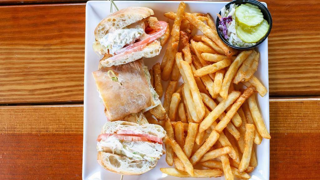 Crispy Buttermilk Chicken Sandwich · hand battered chicken tenders, chipotle mayo, pepper Jack cheese, sliced tomato and apple slaw on ciabatta bread with fries