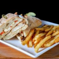 Grilled Chicken Sandwich · Creamy pesto, roasted red pepper, and mozzarella on ciabatta bread with fries.
