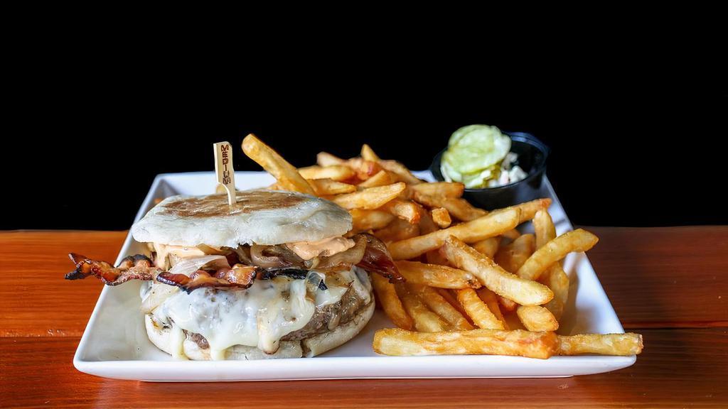 Bacon Swiss Burger · (10 oz) Freshly ground burger, topped with bacon, sauteed onion, Swiss, and bacon aioli on a toasted English muffin with fries.