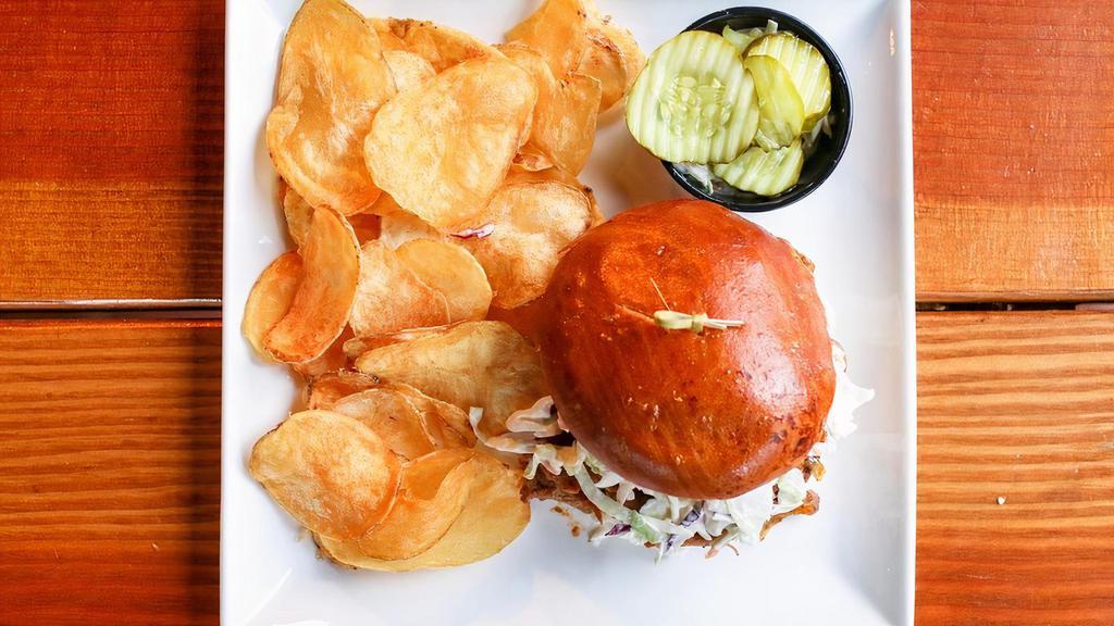 Pulled Pork Sandwich  · Coal fired roasted onions and coleslaw on toasted brioche with kettle chips.