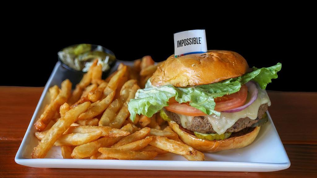 Impossible Meatless Burger · Impossible burger, topped with pepper Jack cheese, onions, pickles, lettuce, tomato, and a mustard aioli sauce with a house salad.