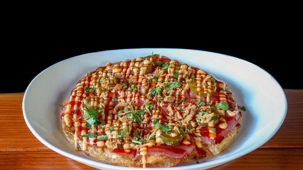 Sushi Pizza · crispy scallion pancake topped with tuna sashimi, jalapenos, spicy mayo, eel sauce and cilantro then dusted with crunchy onions