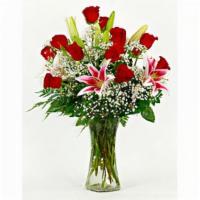 Debi Lilly Unforgettable Deluxe Arrangement · Includes 12 stems of premium Ecuadorian roses, 2 oriental lilies and filler arranged in an h...