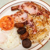 Traditional Irish · Irish bacon, Irish sausage, eggs, grilled tomatoes and black and white pudding with coffee o...