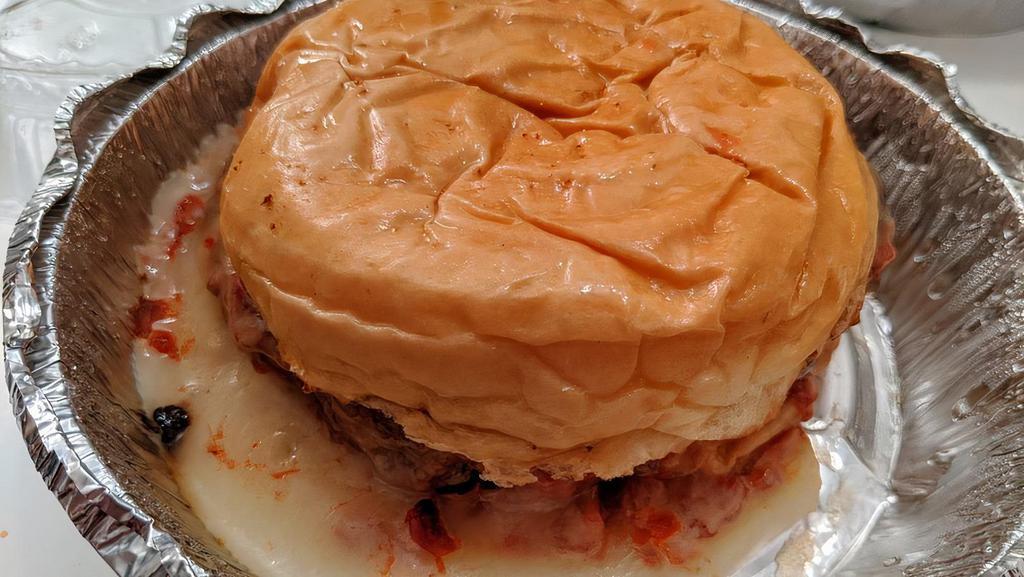 Pizza Burger · Topped with melted mozzarella cheese and tomato sauce.