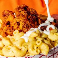 Gluten-Free Buffalo Chick'N Mac N Cheese · Our amazing Gluten-Free Mac-n-Cheese topped with sweet-n-spicy Buffalo Chick'n and a drizzle...