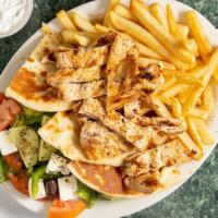 Chicken Souvlaki Platter · Greek salad with grill chicken and french fries. Pita and tzatziki sauce on the side.