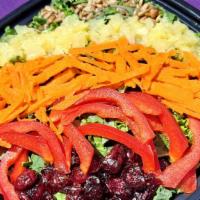 Kale Sunrise · Hearty Kale, Sweet & Tangy Craisins, Red Bell Pepper, Shredded Carrots, & Pineapple topped w...