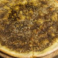 Zaatar Bread · Vegetarian, chef recommendation. Pita topped with olive oil, sesame seeds and herbs.