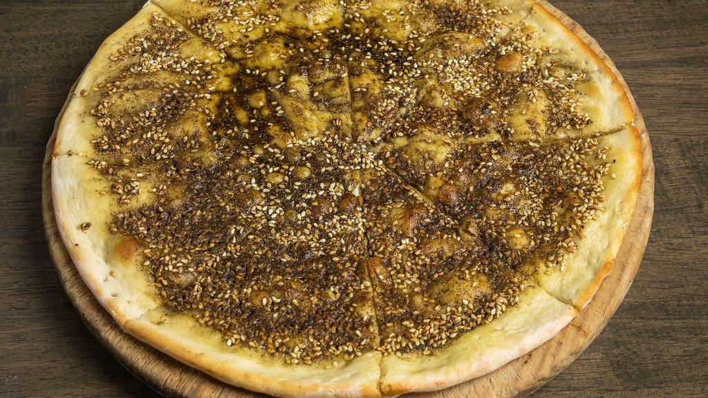 Zaatar Bread · Vegetarian, chef recommendation. Pita topped with olive oil, sesame seeds and herbs.
