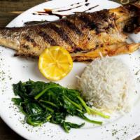 Branzino · Gluten-free, chef recommendation. Baked Greek bass marinated with harissa, served with basma...