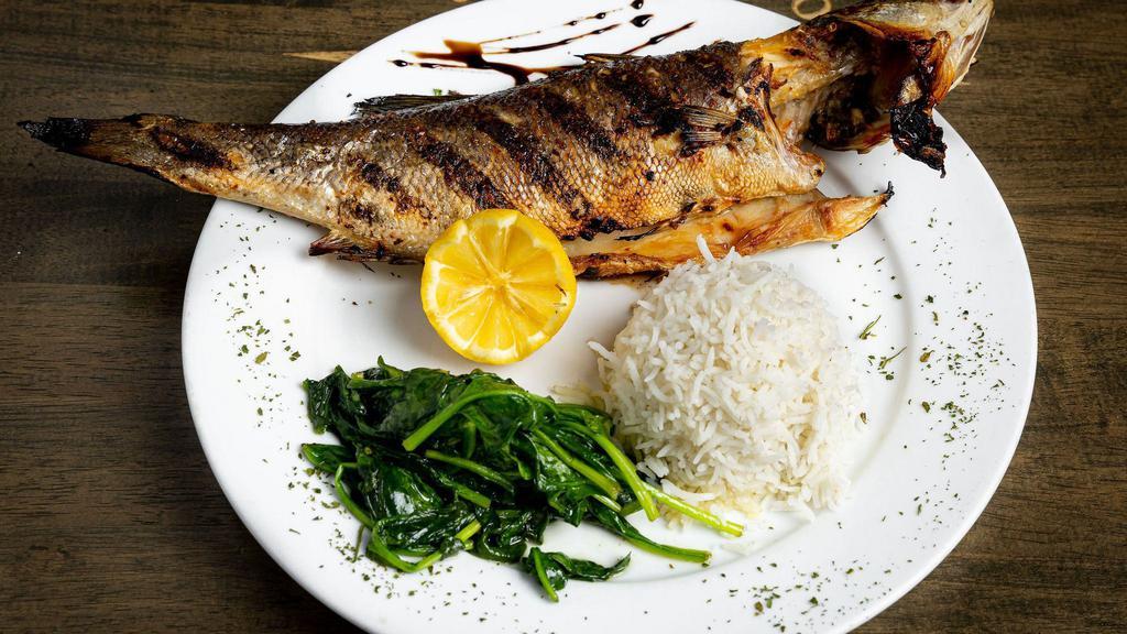 Branzino · Gluten-free, chef recommendation. Baked Greek bass marinated with harissa, served with basmati rice and sauteed spinach.