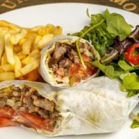 Beef Shawarma · Chef recommendation.  Strips of marinated beef roasted with tahini sauce and onion, tomato p...
