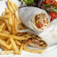 Chicken Shawarma · Strips of marinated chicken thighs with tahini sauce and onion, tomato, parsley & pickles se...