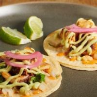 Tacos De Pulpo · Crispy octopus, avocado sauce, chimi sauce, fresh onions, and cilantro.