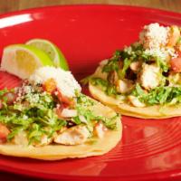 Pollo Tacos · Gluten free. Two shredded chicken tacos topped with cilantro, cotija cheese, and pico de gal...
