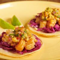 Shrimp Tacos · Gluten free. Two sautéed grilled shrimp tacos topped with white onions, purple cabbage, and ...