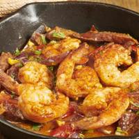 Camarones Calientes · Spicy. Sautéed shrimp with Mexican chorizo with red onions and elote, served with corn torti...