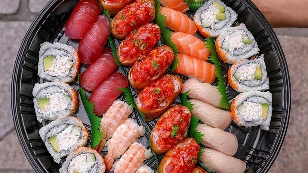 #6. Deluxe Sushi Platter  · ,8 piece California Roll,4 piece each of salmon,ahi, Hamachi,Ebi,8 piece Spicy ahi bomb