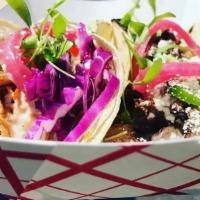 Beef Barbacoa Tacos (3) · Braised beef, shredded cabbage, jalapeño, chipotle crema, on corn tortillas served with pota...