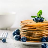 Blueberry Pancakes · 3 Perfectly cooked buttermilk pancakes topped with fresh blueberries.