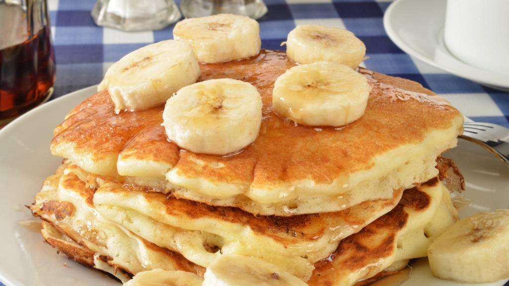 3 Fluffy Pancakes With Banana Slices · 3 Perfectly cooked buttermilk pancakes topped with fresh banana slices.