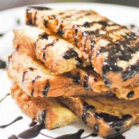 3 Slices Of French Toast With Chocolate Chips · 3 Perfectly cooked French Toast slices, topped with sweet chocolate chips.