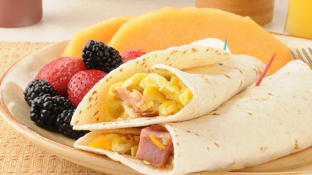 Classic Egg Wrap · Delicious Breakfast wrap topped with Ham, Two Eggs, Cheese & Home Fries. Served on customer's choice of wrap.