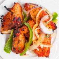 Tandoori Chicken · Served on a bed of grilled onions bell peppers and lemon mint and tamarind chutney. dishes c...