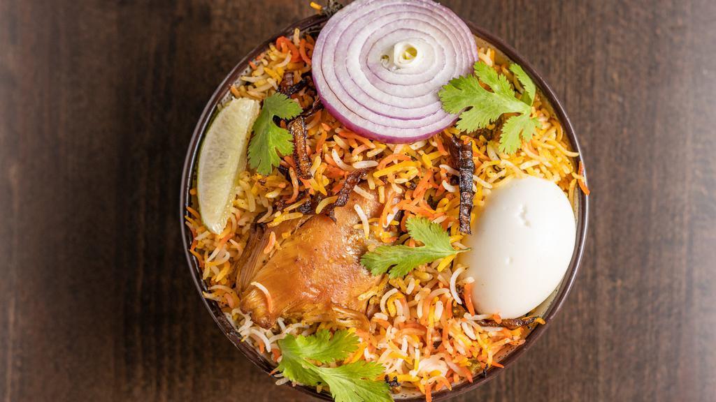 Chicken Dum Biryani · Chicken with bone cooked in Basmati rice with special herbs and spices.