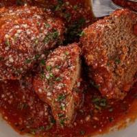 Side Of Beef Meatballs · Our famous beef meatballs braised in our house marinara sauce topped with a dollop of creamy...