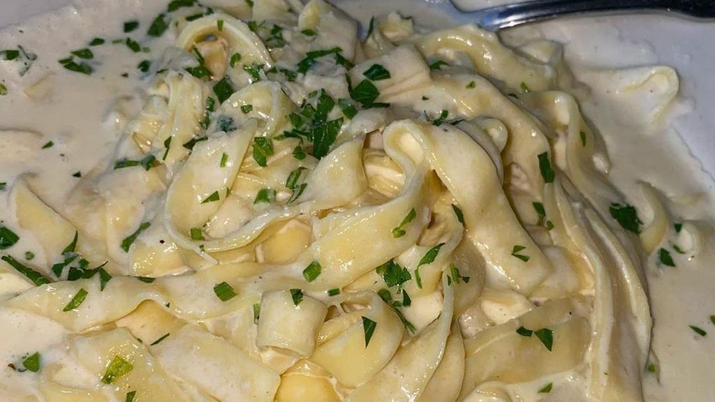 Traditional Fettuccine Alfredo · A rich Parmesan infused cream sauce. Always prepared to perfection