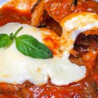 Traditional Eggplant Parm Dinner · Golden fried eggplant cutlets in tomato sauce topped with mozzarella cheese. Served with you...