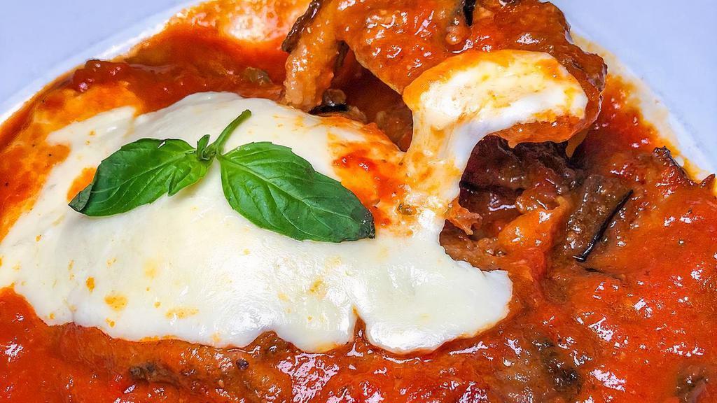 Traditional Eggplant Parm Dinner · Golden fried eggplant cutlets in tomato sauce topped with mozzarella cheese. Served with your choice of pasta or salad