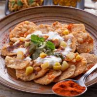 Vegan Papdi Chaat · Crispy pastry bites topped with date sauce and chickpeas.
