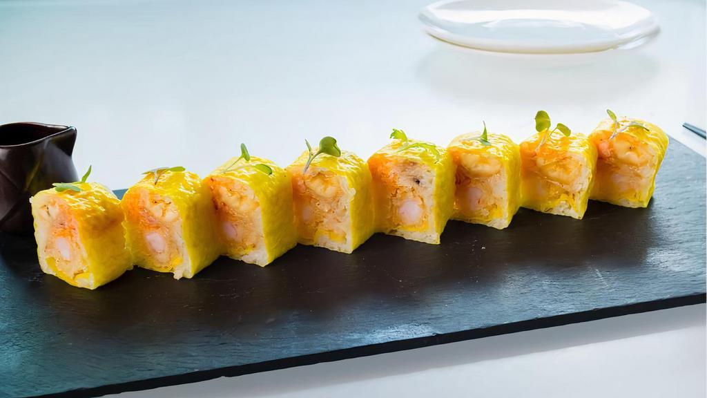 Paradise Roll · Spicy lobster, shrimp tempura and fried banana, wrapped with soy paper, yuzu mango sauce.