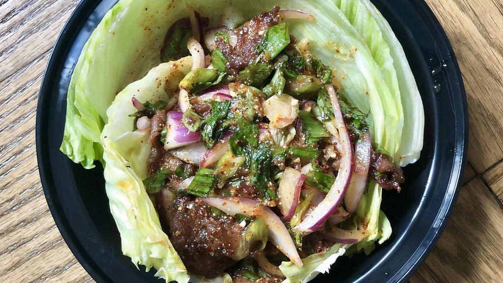 Spicy Beef Salad · Spicy. Grilled beef with red onion, white onion, mints, thai rice powder, thai dry chili, scallion and thai spicy lime dressing.