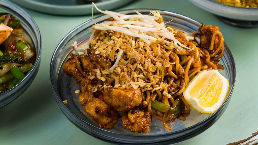 Spicy Mee Goreng Noodle · Spicy. Egg noodle, garlic, egg, peanut, tofu, beansprout, tomato, bell pepper, chili, bail, lemongrass paste, and fried onion on top.