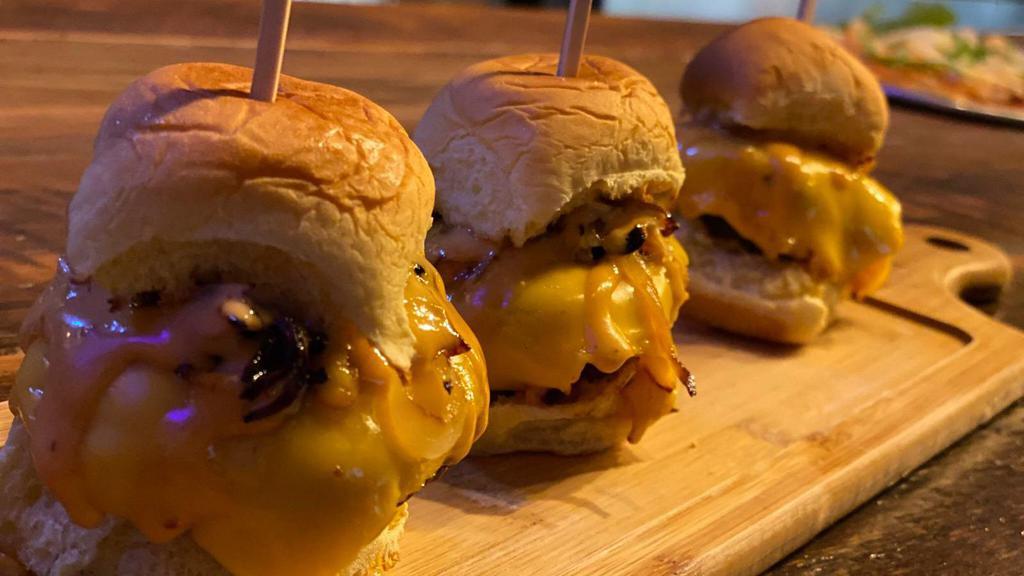 Beef Sliders (3) · 100% angus beef patties, cheese, caramelized onions, pickles, chipotle mayo.