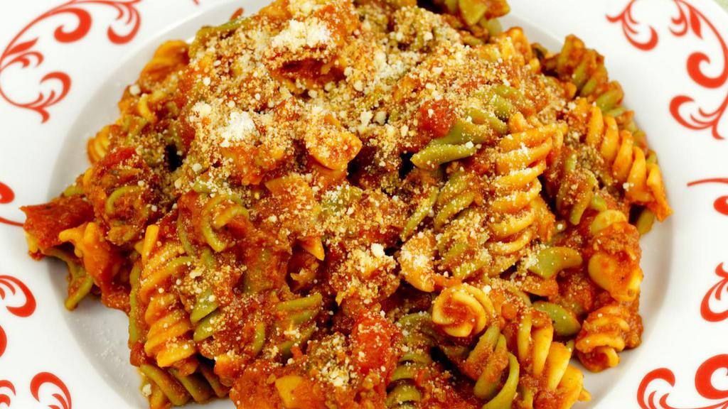Tri-Color Spirale · Tri-color spirale pasta with chicken, fresh mozzarella, grape tomatos, tomato sauce topped with parmesan cheese.