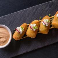 Jalapeño Poppers · 6 pieces of jalapeño poppers filled with cheddar cheese, battered and fried to perfection. S...