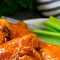 Buffalo Wings  · 7 pieces wings of a chicken coated in sauce and served with blue cheese dressing.