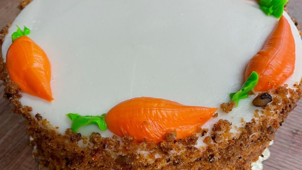 Carrot Cake · Made with fresh carrots, honey, walnuts covered in cream cheese icing.  Very moist.