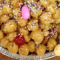 Honey Balls/Strufoli 1Lb. · Traditional little balls covered in honey, orange zest, hazel nuts, almonds and more.