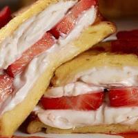 Stuffed Strawberry Cream Cheese French Toast · Three slices of French toast stuffed with strawberry cream cheese and topped with fresh stra...