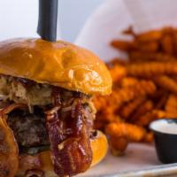 Saratoga Bbq Burger · 8 oz. Signature blend topped with bacon, onion straws, BBQ sauce and pickles, served on a to...