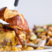 Mac Attack Burger · 8 oz. Signature blend with bacon, smothered with mac and cheese and cheese sauce, served on ...