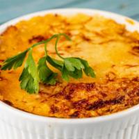 Pastitsio · Layers of thick Greek macaroni and ground beef topped with béchamel cream baked.