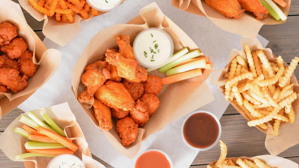 30 Classic Bone-In Wing Party Box · Party-size, ready-to-go boxes of 30 Classic bone-in chicken wings tossed with up to 3 wing flavors and served with fresh carrot & celery sticks and homemade buttermilk ranch or blue cheese dressing + Fries.
