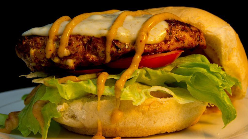 Cajun Chicken Sandwich · Cajun Chicken sandwich served with cheese, lettuce, and tomato.